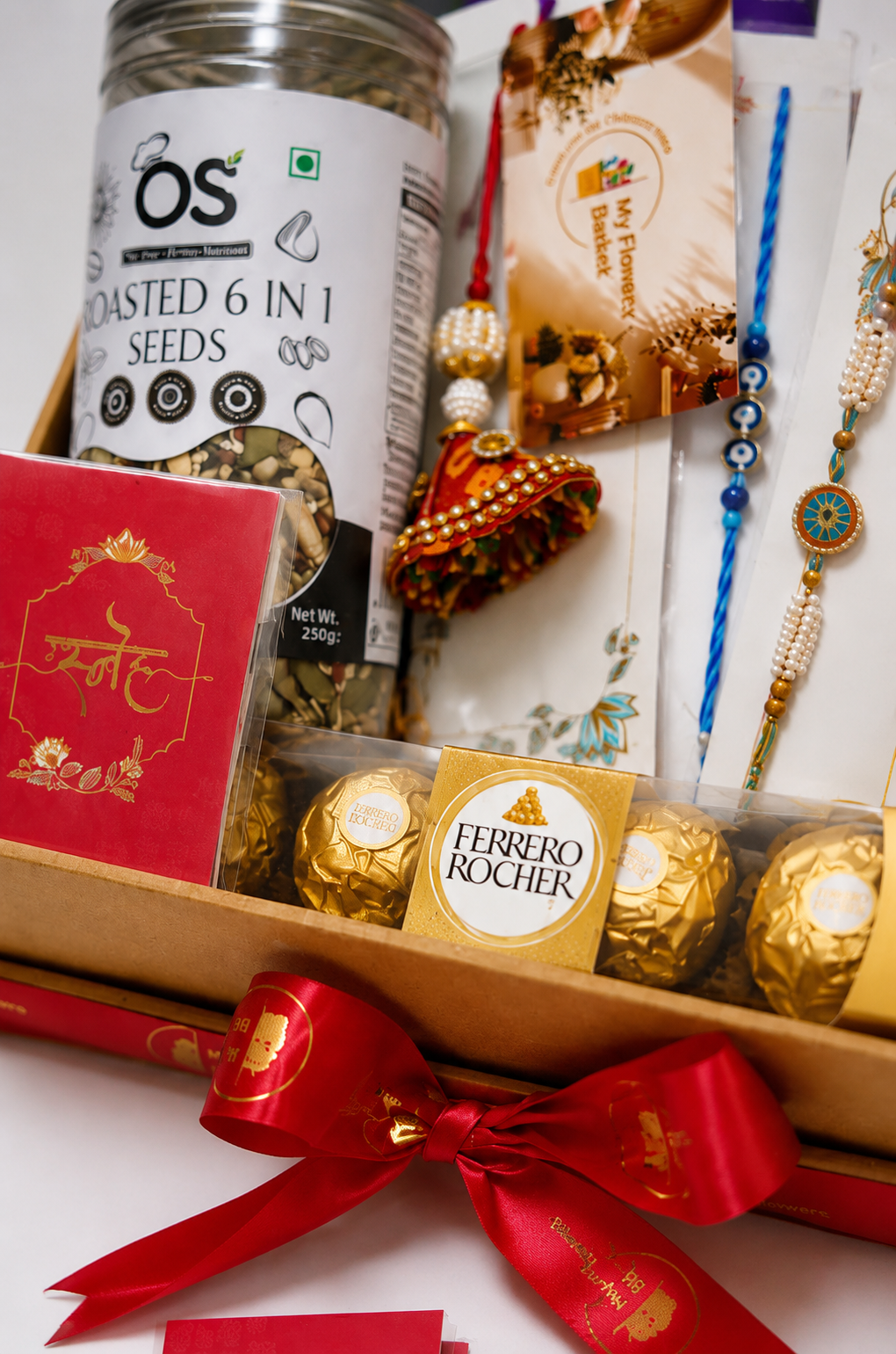 Premium Rakhi Gift Hamper for Brother with Ferrero Rocher chocolates, Cadbury chocolates, roasted seeds, designer rakhis and festive gift box